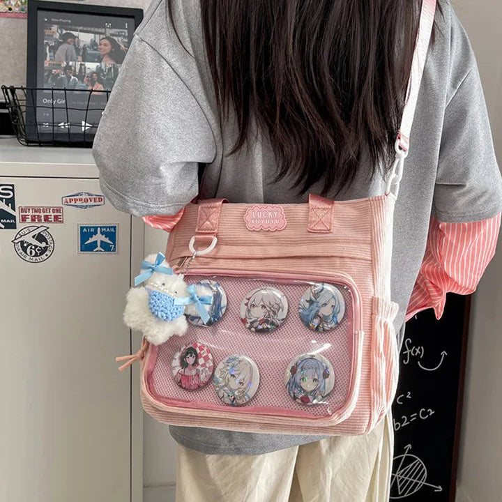 Person wearing a pink Kawaii crossbody bag with character pins and a fluffy accessory.