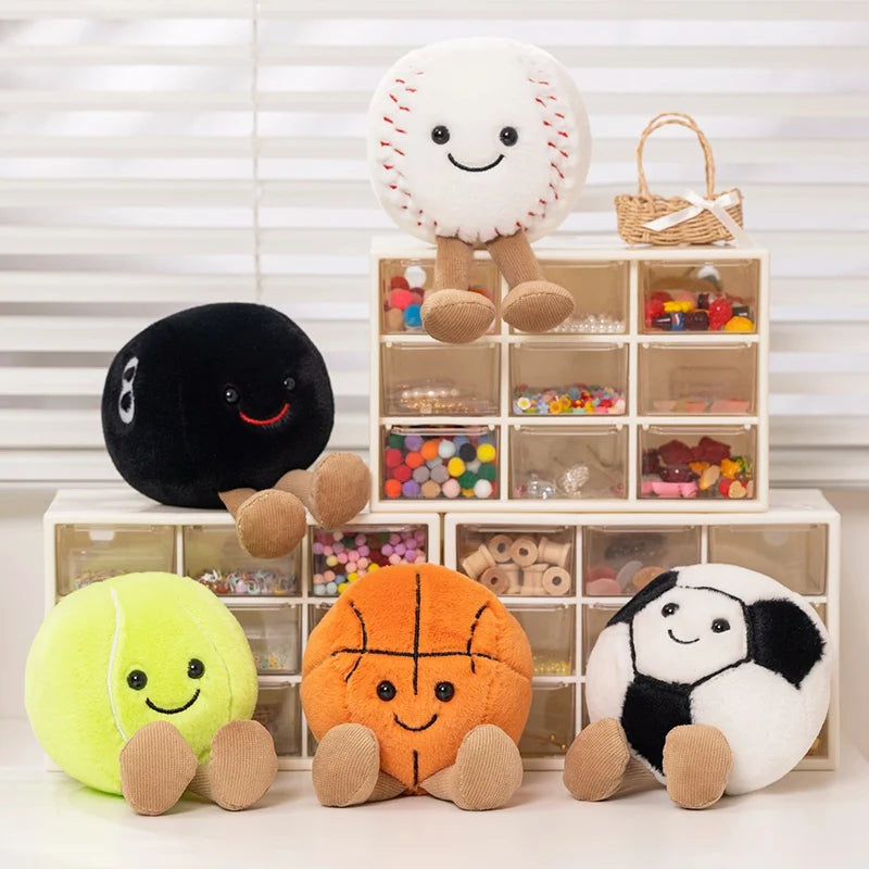 Plush kawaii toys shaped like a tennis ball, basketball, soccer ball, and others in front of a storage unit with more toys.