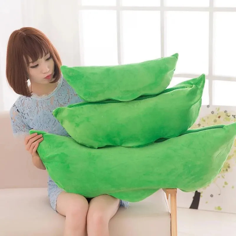 Woman holding green kawaii pillows in a room with a white wall and floral decorations.
