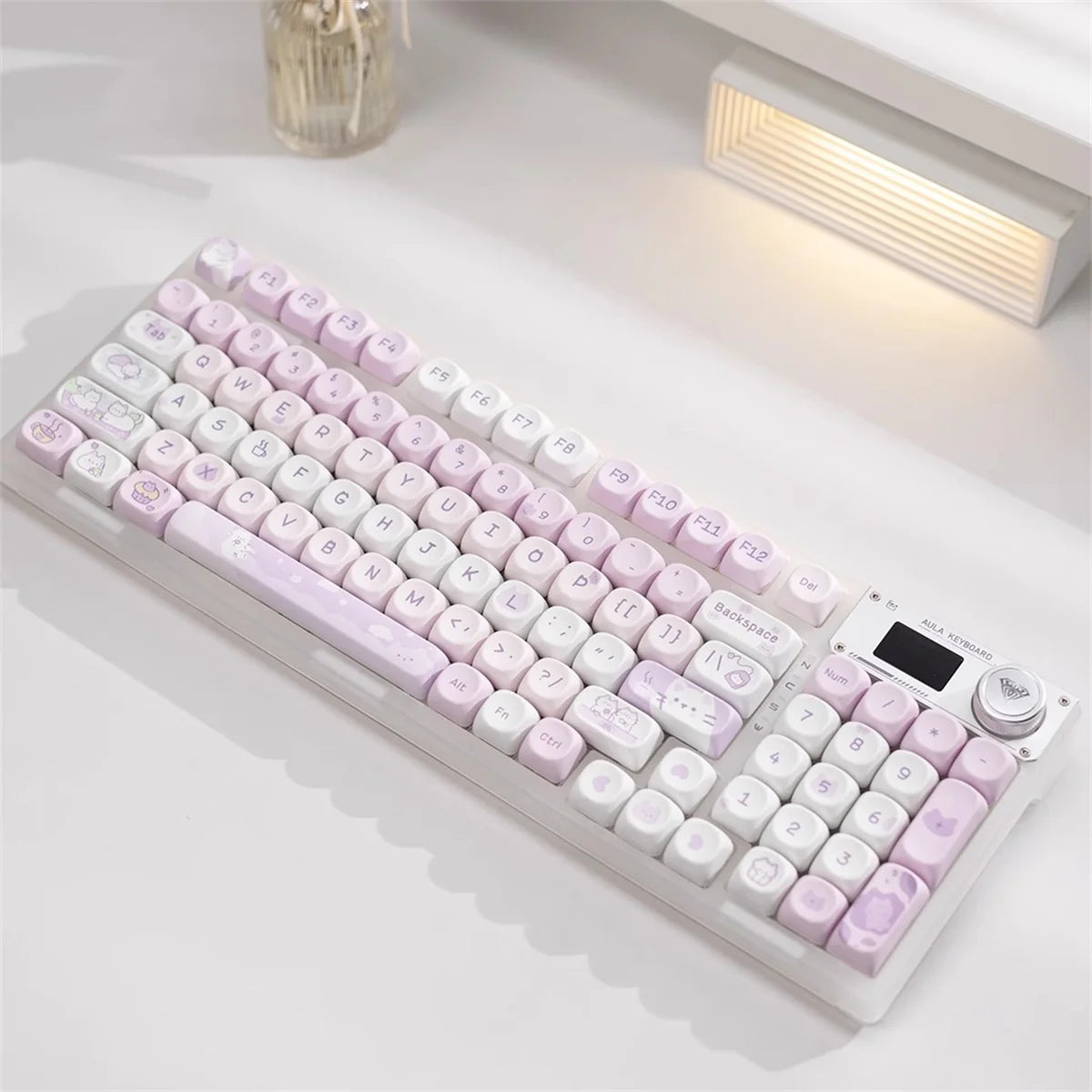 Mechanical Kawaii keyboard with pink and white keys on a light surface