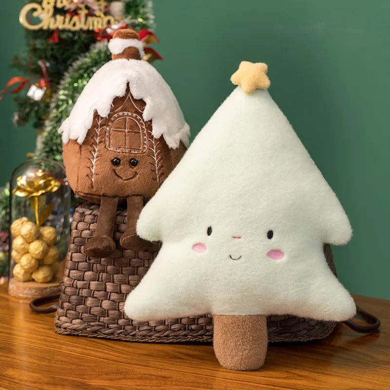 Kawaii plush toy gingerbread house and tree with a Christmas tree and decorations in the background.