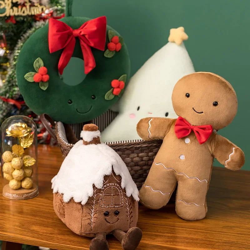 Christmas-themed kawaii plush toys including a gingerbread man and a Christmas wreath on a wooden surface.