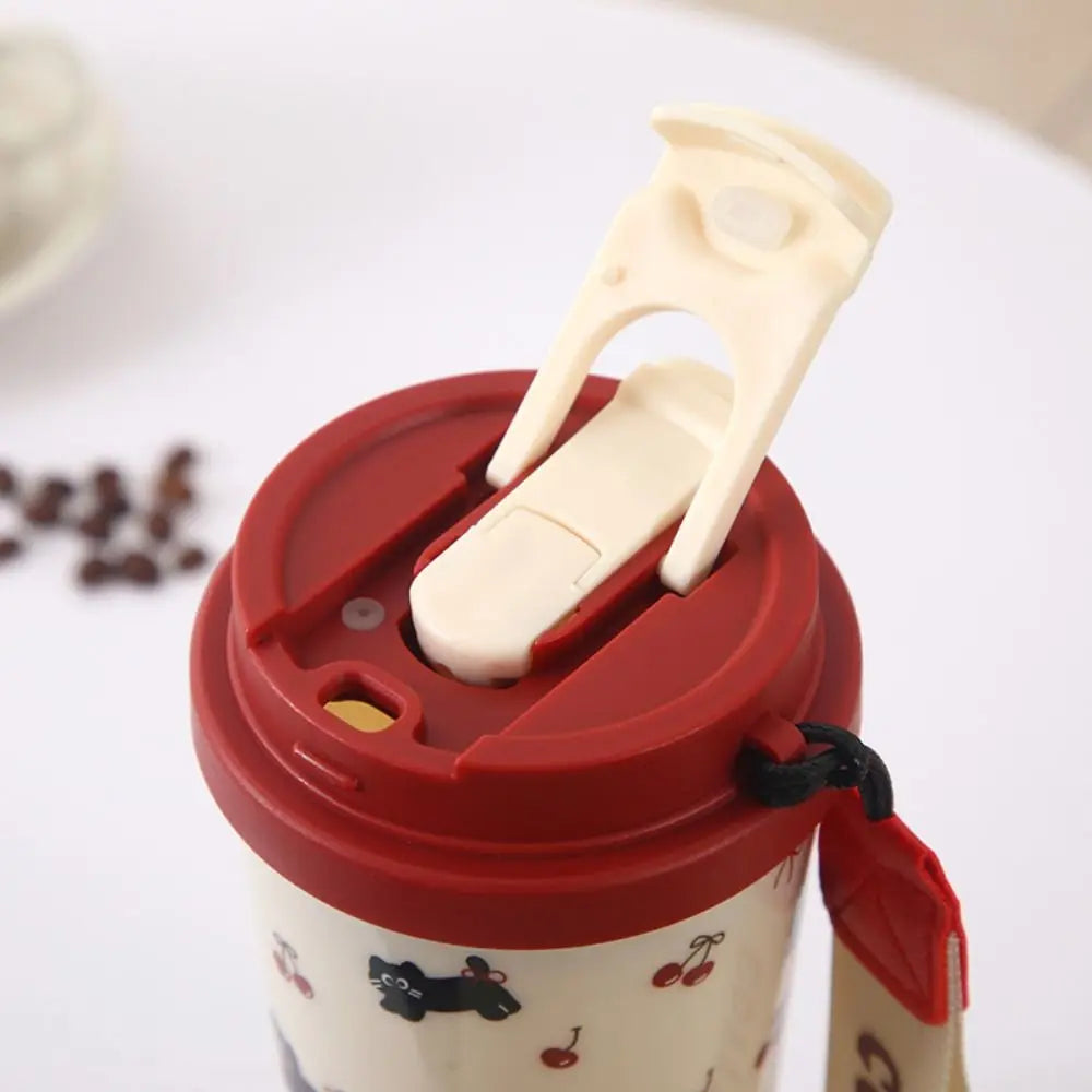 Red lid with a white handle on a Kawaii coffee cup, surrounded by coffee beans.