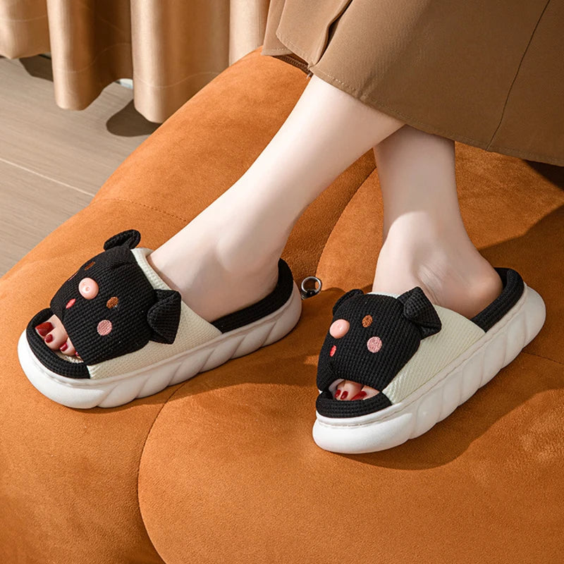 Children's kawaii sandals with black straps and pink polka dots on a brown cushion.