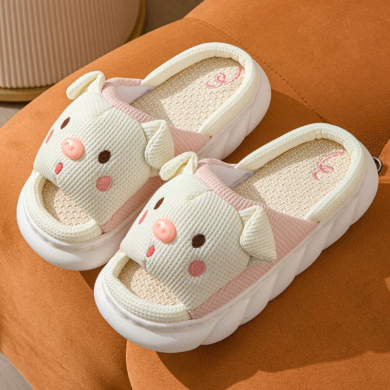 Pair of cartoon kawaii cat slippers on a brown surface
