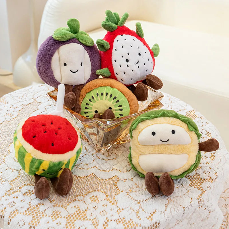 Plush kawaii toys shaped like fruits and vegetables on a lace tablecloth.