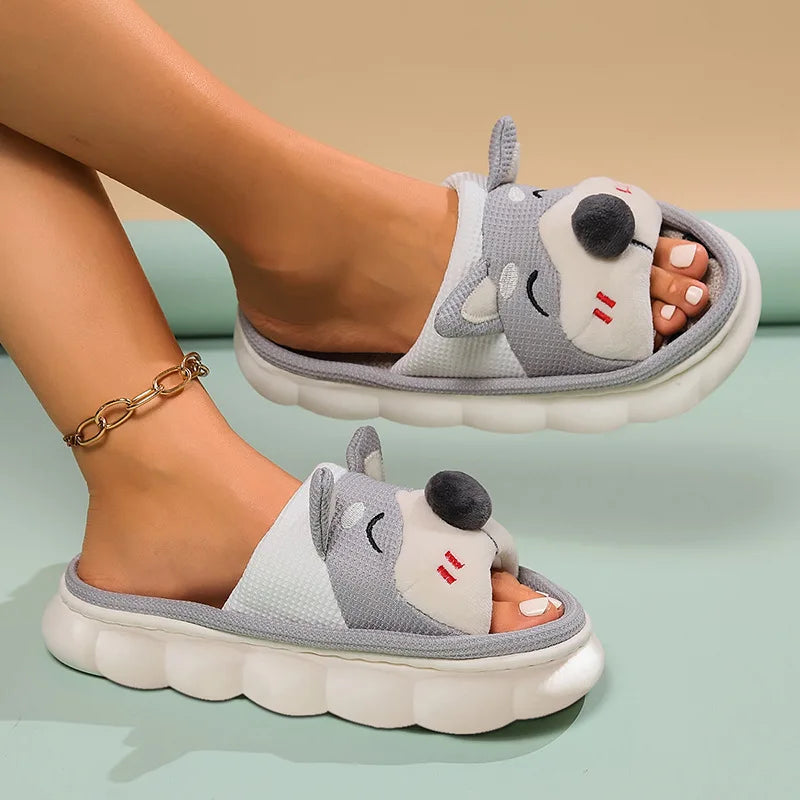 Gray cartoonish kawaii slippers worn by a person on a light green background