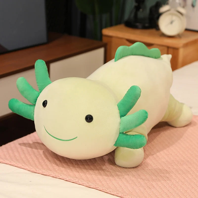 Plush kawaii toy axolotl on a pink blanket with a blurred background