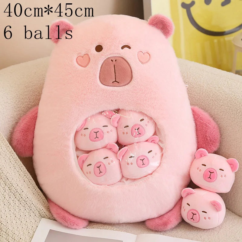 Pink bear-shaped kawaii plush toy with six smaller bear plush toys inside, on a beige surface.
