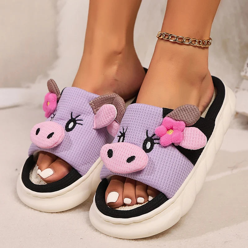 Purple unicorn kawaii slippers worn by a person on a light background