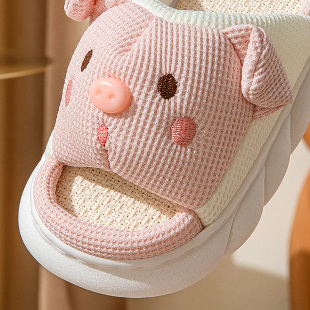 Pink kawaii cartoonish slipper with a face design on a white background