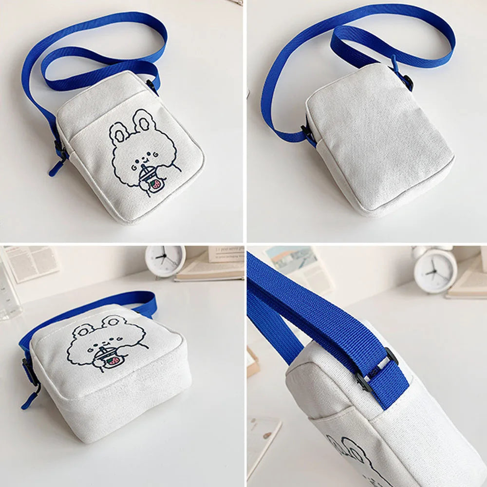 Small white bag with blue strap and Kawaii cartoon design on a light background