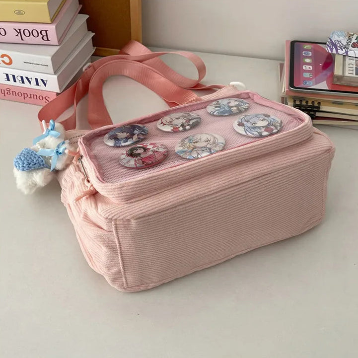 Pink fabric Kawaii bag with decorative elements on a light surface