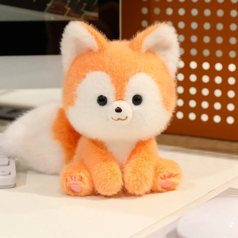Plush kawaii toy fox sitting on a surface with a blurred background
