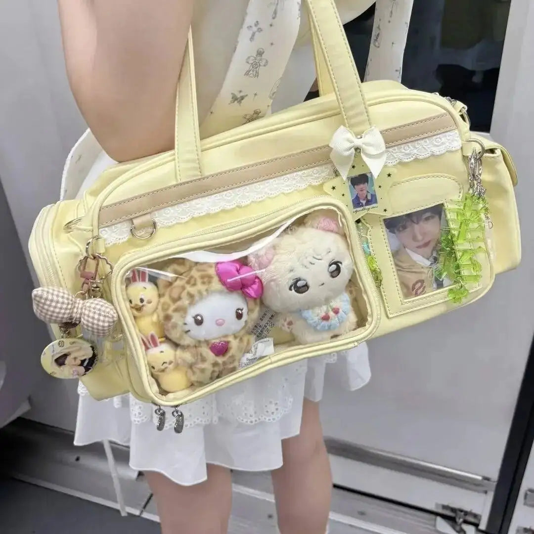 Yellow Kawaii handbag with plush toys and decorative elements held by a person.