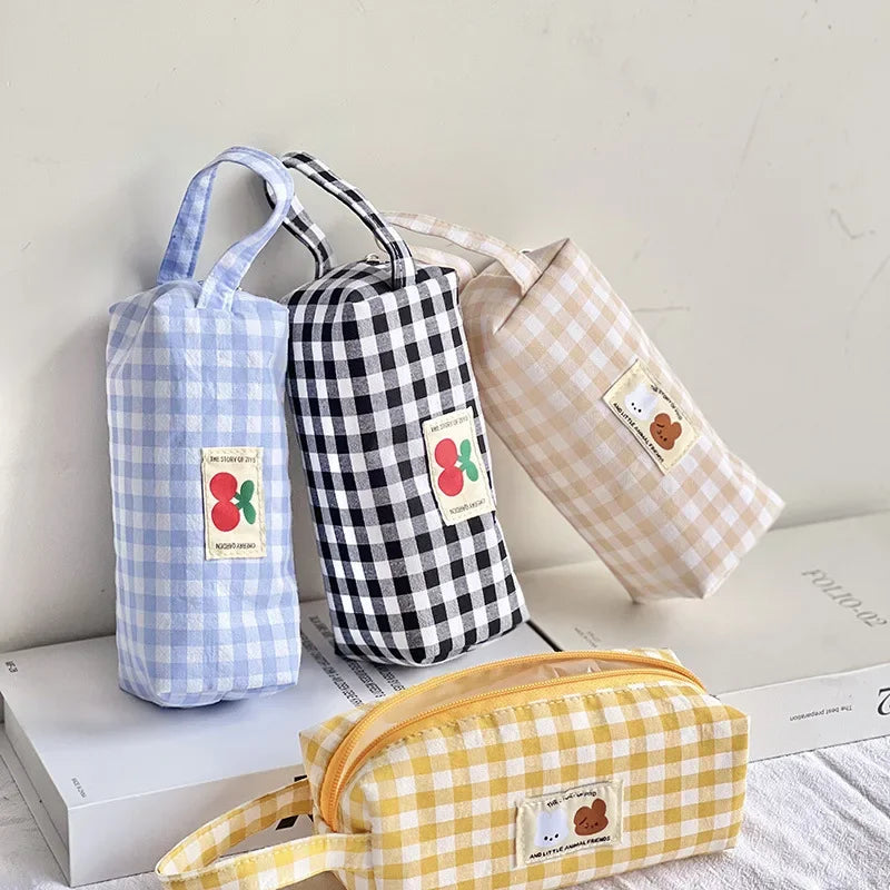 Four gingham-patterned kawaii bags in different colors on a light surface.