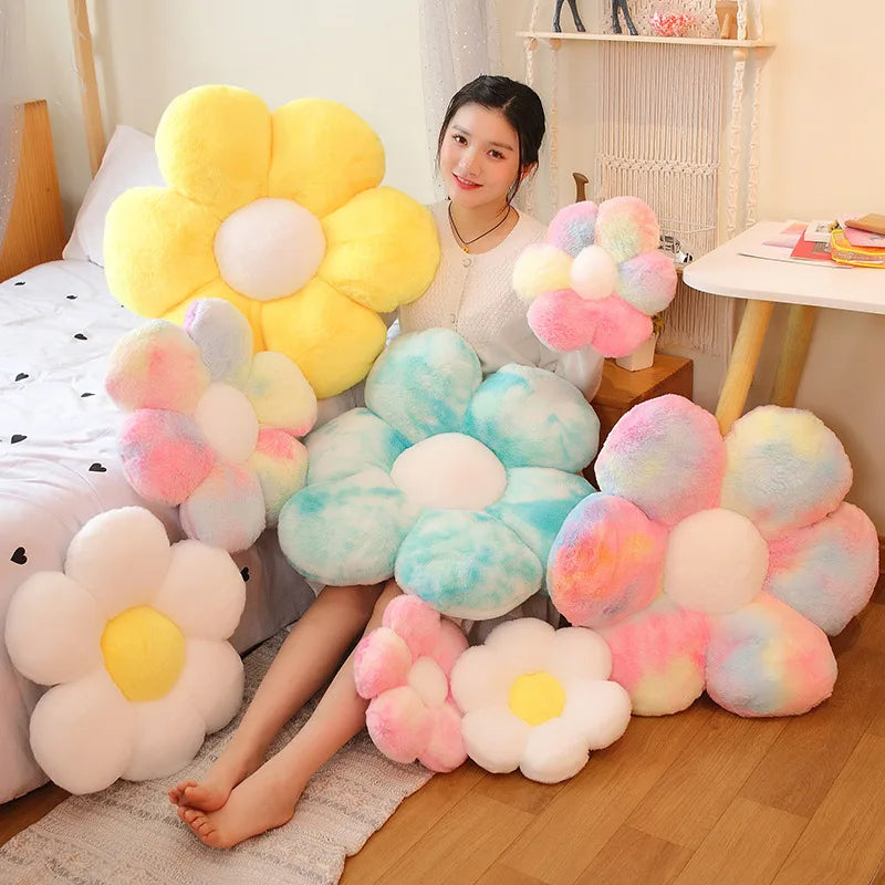 Woman surrounded by colorful Kawaii flower-shaped pillows in a room.