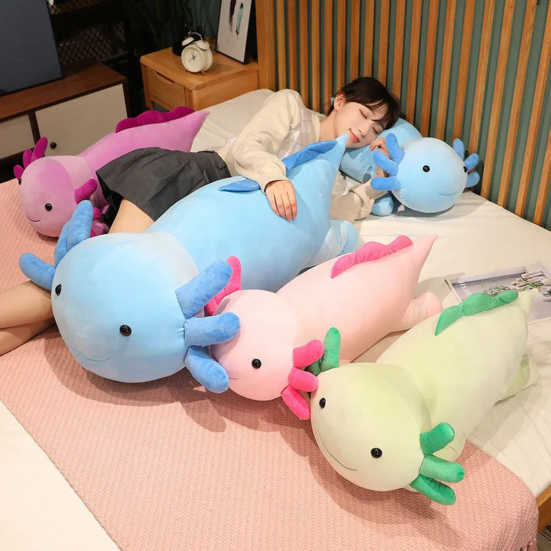 Person lying on a bed with colorful axolotl plush kawaii toys.
