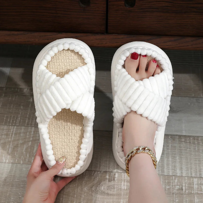 White kawaii slippers with textured sole on a wooden floor