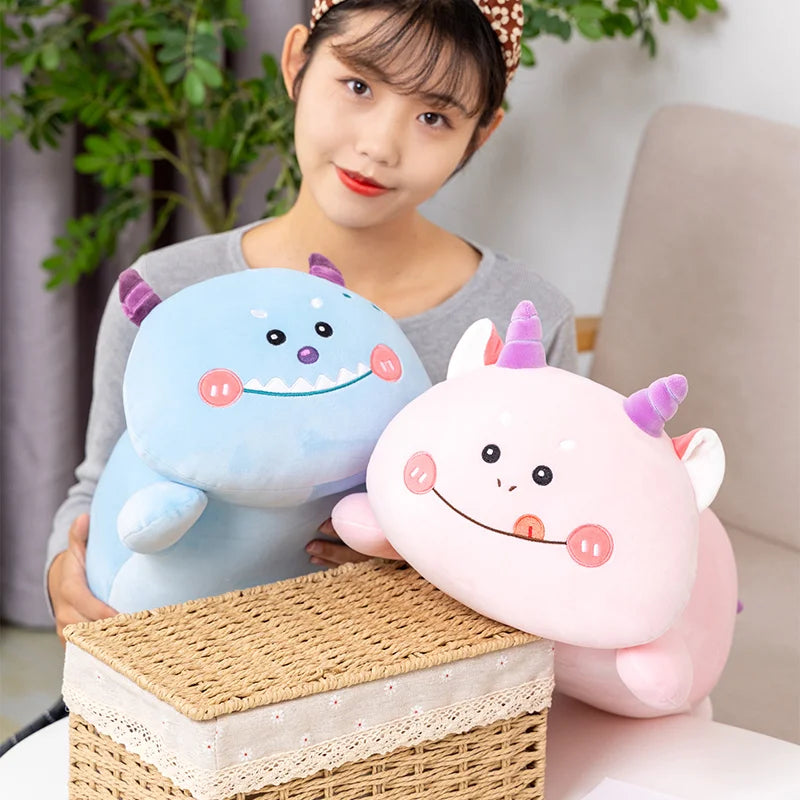 Person holding two colorful kawaii plush toys on a woven box with a blurred indoor background