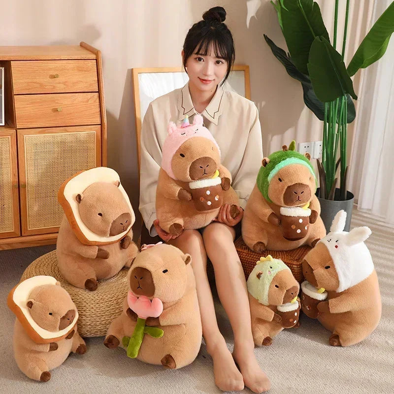 Woman sitting on a chair surrounded by various plush kawaii toys resembling animals in different hats.