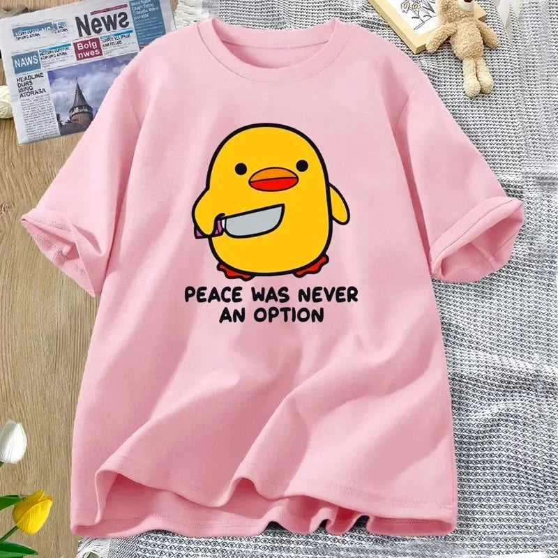 Pink t-shirt with a yellow kawaii duck graphic and text on a textured surface.