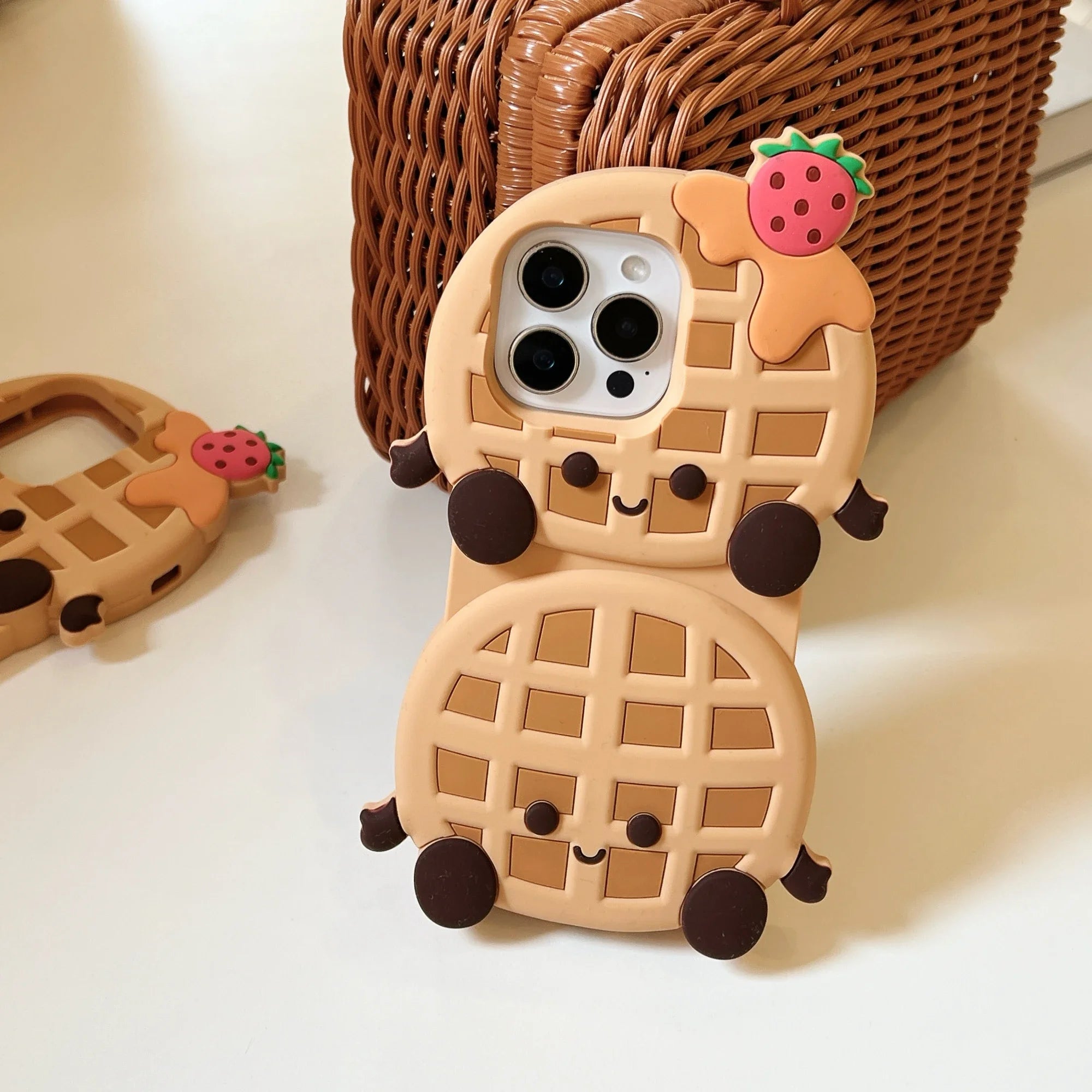 Kawaii waffle-shaped phone case with a strawberry on a light background