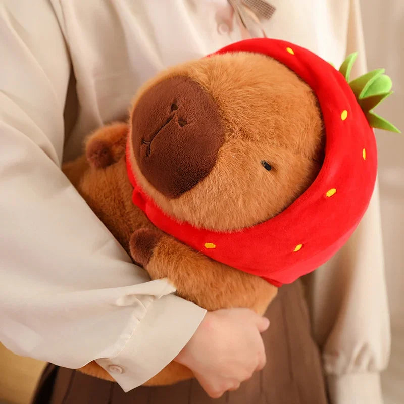 Plush toy resembling a kawaii bear in a strawberry costume held by a person.