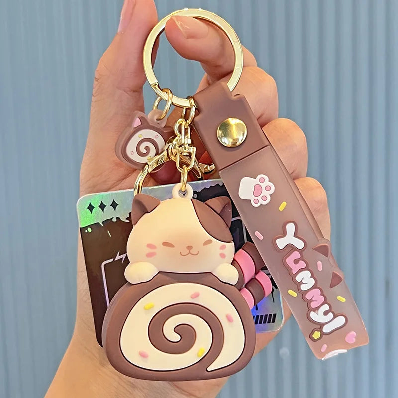 Cute keychain with kawaii cartoon character design held by a hand against a light blue background