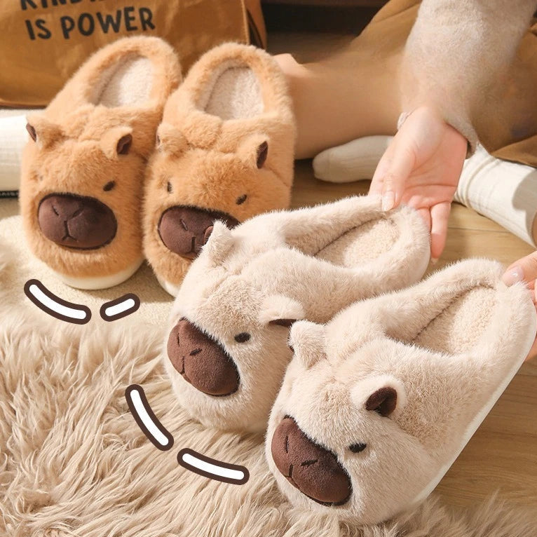 Pair of plush animal kawaii slippers with a cartoon face design on a fluffy surface.