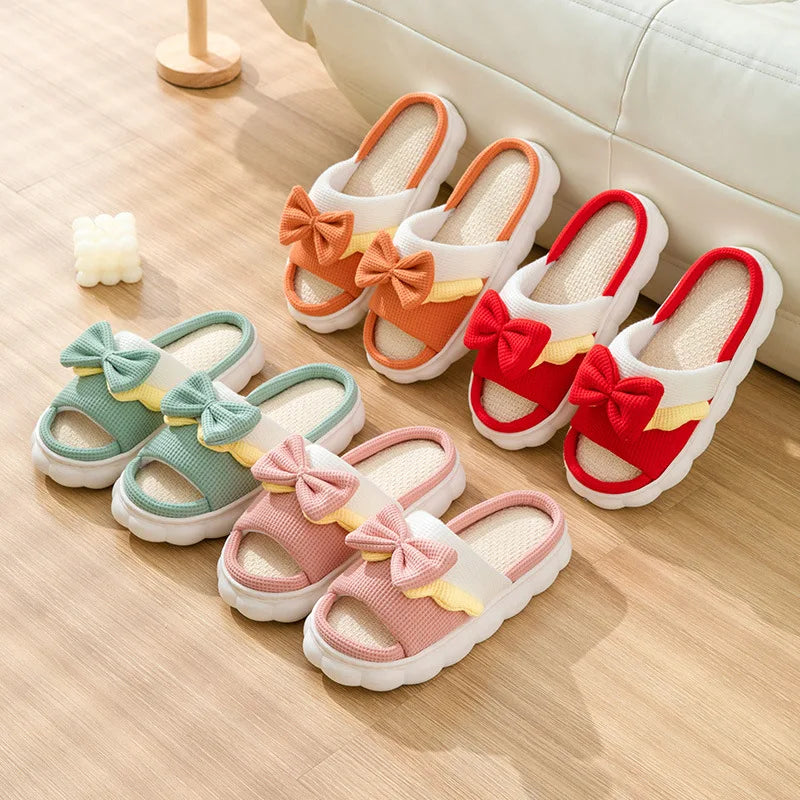 Colorful kawaii sandals with bow details on a wooden floor.