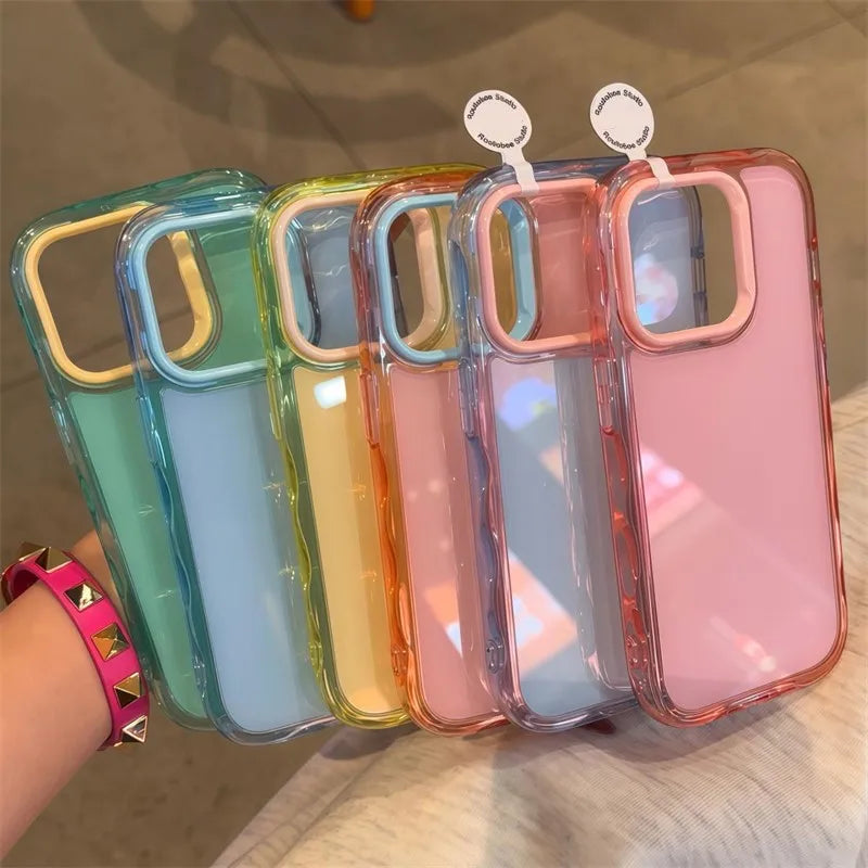 Five transparent kawaii phone cases in different colors held by a hand with a pink bracelet.