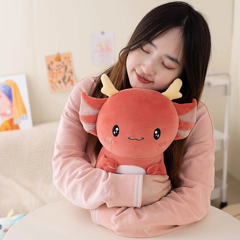 Person holding a kawaii plush axolotl toy in a cozy indoor setting