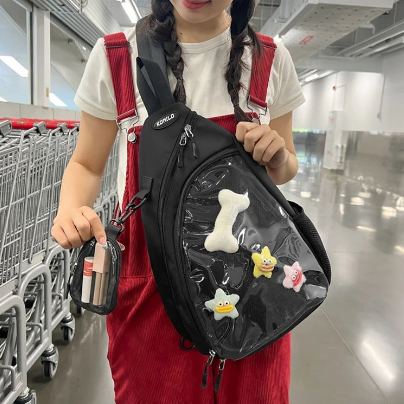 Person wearing a black Kawaii sling bag with colorful patches in a shopping mall.