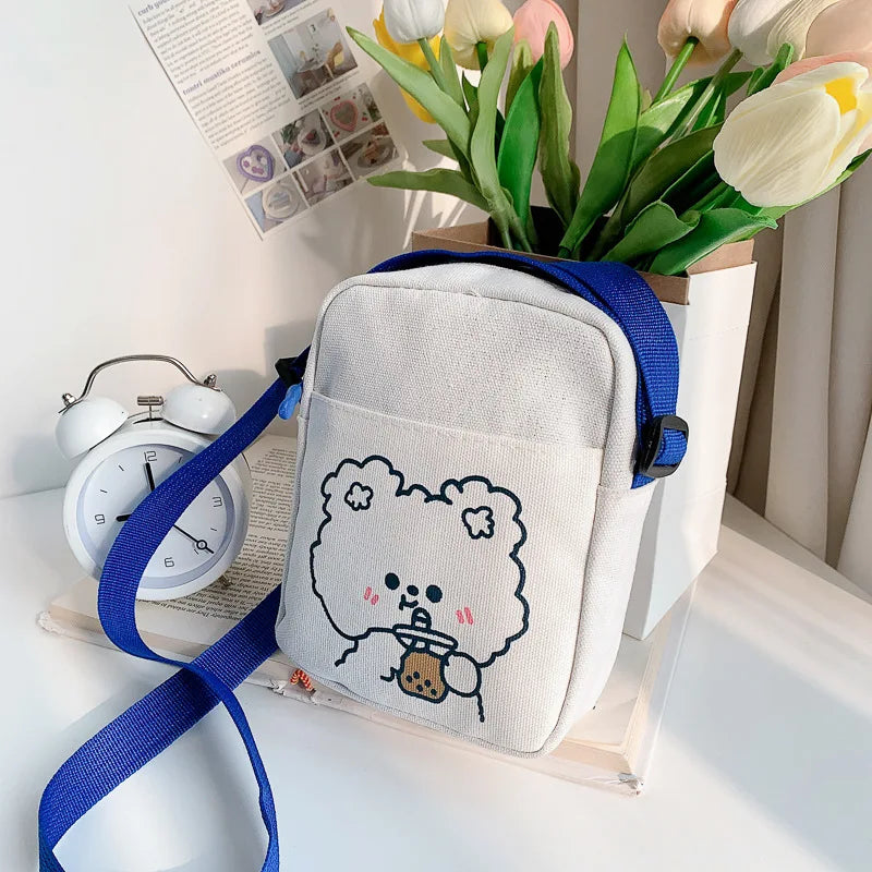 Small white bag with a Kawaii cartoon character on a surface with flowers and an alarm clock in the background