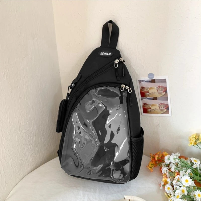 Black Kawaii sling bag with transparent side panel on a light surface with flowers in the corner