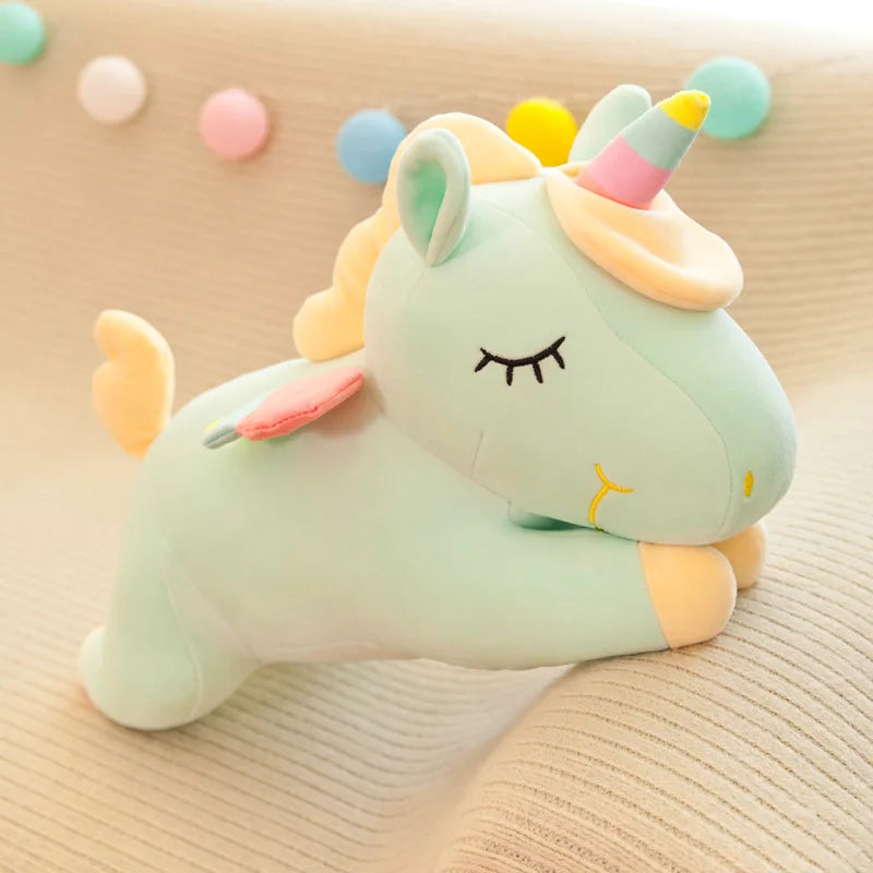 Plush unicorn kawaii toy with a rainbow-colored horn on a beige surface