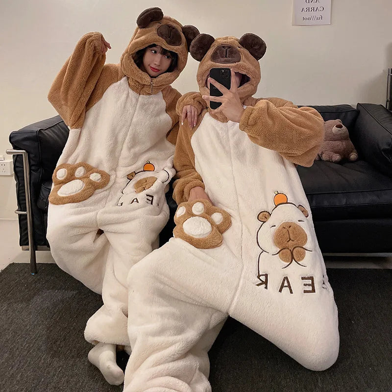 Two people in kawaii bear-themed pajamas taking a selfie in a living room.