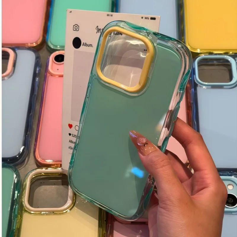 Hand holding a clear kawaii phone case with a green tint against a colorful background of phone cases.