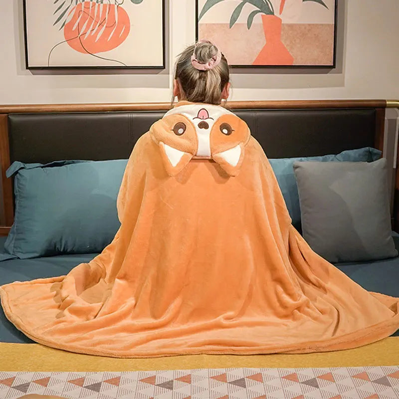 Person sitting on a couch wearing an kawaii orange animal-themed blanket