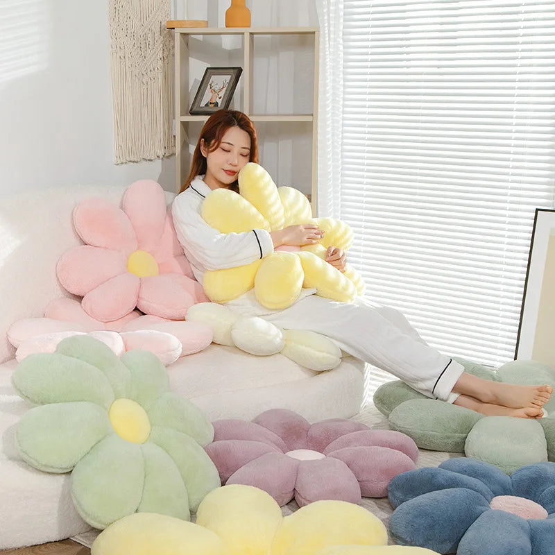 Woman sitting on a couch surrounded by colorful Kawaii flower-shaped cushions in a bright room.
