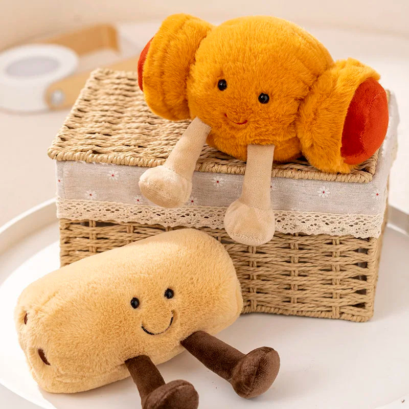 Two kawaii plush toys resembling a carrot and a potato on a white surface with a woven basket.