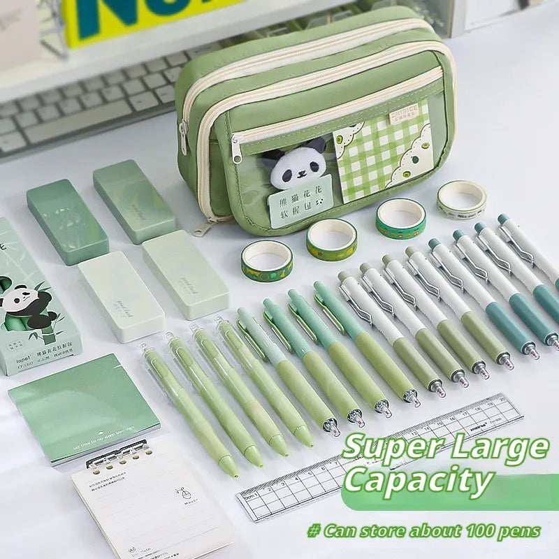 Collection of green kawaii stationery items including pens, notebooks, and a pencil case on a white surface.