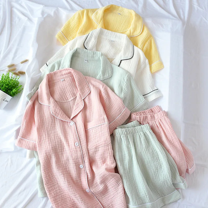 Set of kawaii pastel-colored pajama sets on a white surface