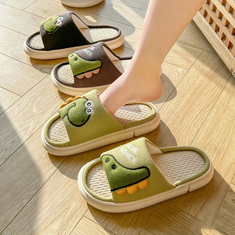 Green slippers with kawaii frog design on a wooden floor