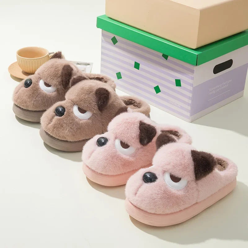 Pair of brown and pink kawaii slippers with animal face design on a light background