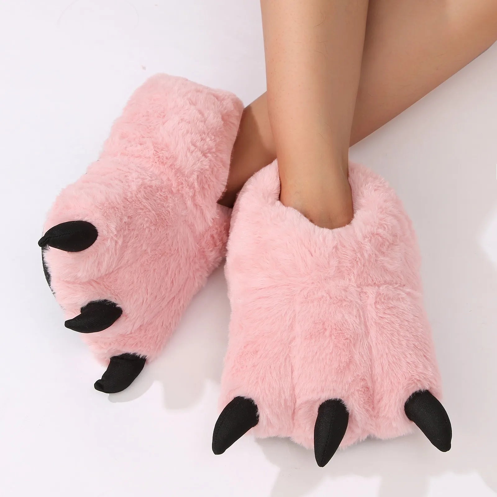 Pink fluffy kawaii slippers with black toes on a white background