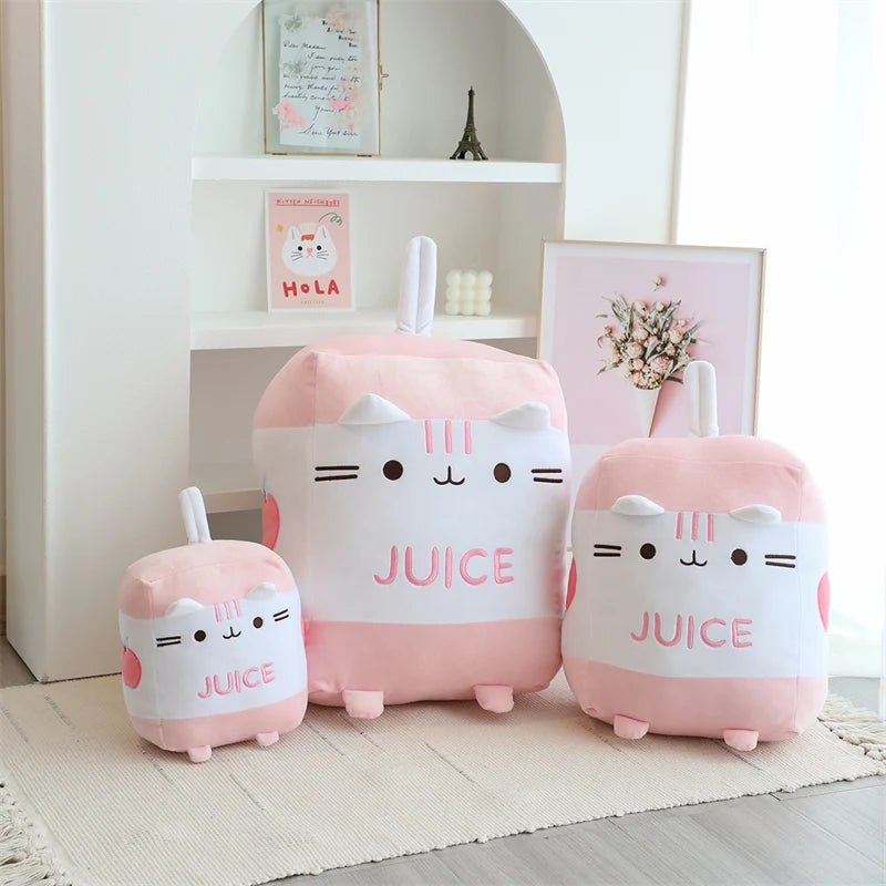 Set of pink and white kawaii plush toys with 'Juice' text on a light wooden floor.