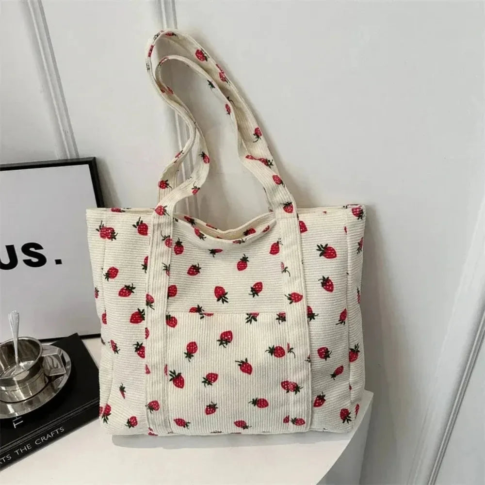 Tote bag with kawaii strawberry pattern on a white surface