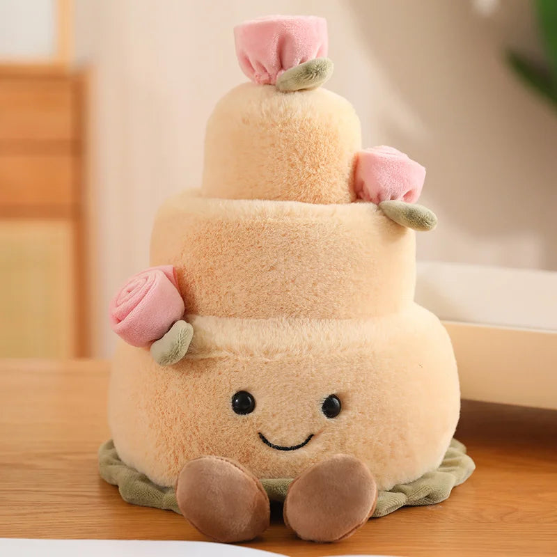 Plush kawaii toy resembling a three-tiered cake with a smiling face on a wooden surface.